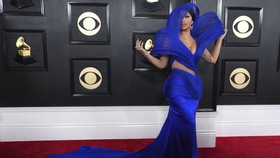Cardi B added an Indian touch to the Grammys red carpet as she wore an ensemble from Gaurav Gupta's couture label. The gown featured the Indian designer's signature architectural additions, cut-outs on the waist, a figure-hugging silhouette, a floor-sweeping long train, and a plunging neckline. Diamond jewels, high heels, a sleek hairdo, and on-fleek glam rounded it off. (AP)
