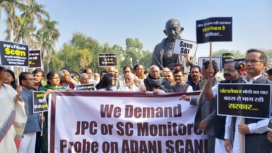 Congress president Mallikarjun Kharge and other leaders and members protesting near the Gandhi statue on Parliament premises, demanding a JPC or Supreme Court-monitored probe into Adani crisis.(HT Photo/Sanjeev Verma)