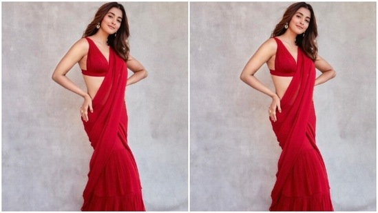 Pooja teamed her saree with a sleeveless matching red blouse and posed for the pictures.&nbsp;(Instagram/@hegdepooja)