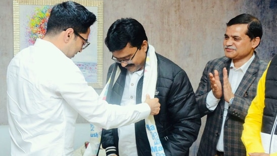 BJP MLA Suman Kanjilal is being gifted TMC scarf by pary National General Secretary Abhishek Banerjee, in Kolkata. (PTI)