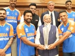 PM Modi holds the T20 World Cup trophy as the Indian cricketers sport a smile PM Modi holds the T20 World Cup trophy as the Indian cricketers sport a smile