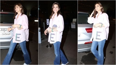 Kriti Sanon shows us how to look casual yet stylish in her latest airport look. The actress wore an oversized pink skirt adorned with trendy patchwork down the side. She styled it with bell-bottom jeans and a pair of white shoes. (HT photo/VarinderChawla) Kriti Sanon shows us how to look casual yet stylish in her latest airport look. The actress wore an oversized pink skirt adorned with trendy patchwork down the side. She styled it with bell-bottom jeans and a pair of white shoes. (HT photo/VarinderChawla)