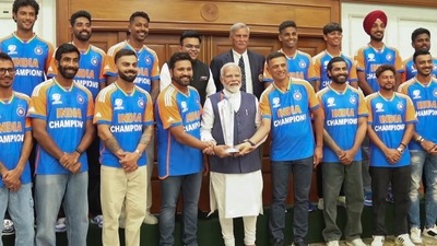PM Modi posed for a photo with the Indian team, alongwith the World Cup trophy. (PTI) PM Modi posed for a photo with the Indian team, alongwith the World Cup trophy. (PTI)