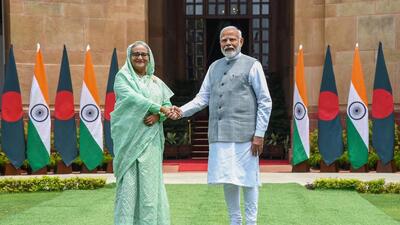 India's Prime Minister Narendra Modi shaking hands with his Bangladesh's counterpart Sheikh Hasina (L) upon their arrival at the Hyderabad house in New Delhi. (PTI)