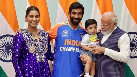 PM Modi holding Jasprit Bumrah and Sanjana Ganesan's son Angad in his arms. 