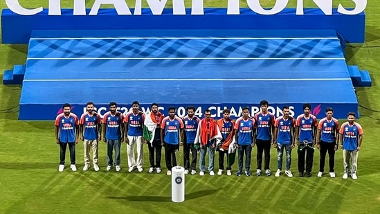 Team India Victory Parade Highlights: The T20 World Cup-winning Indian cricket team with the championship trophy during their felicitation ceremony.