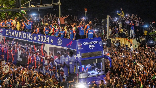 Players acknowledge fans during their open bus victory parade.(PTI)