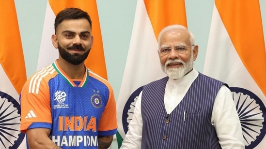 Prime Minister Narendra Modi with cricketer Virat Kohli during a meeting with the T20 World Cup-winning Indian cricket team(PTI)