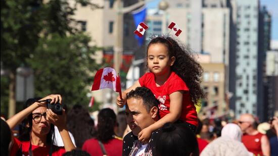 People celebrate Canada Day on Parliament Hill, in Ottawa, Ontario, on Monday. (REUTERS)