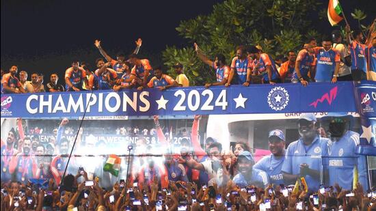 Players of the T20 World Cup-winning team acknowledge fans during their open bus victory parade, in Mumbai, on Thursday. (PTI)