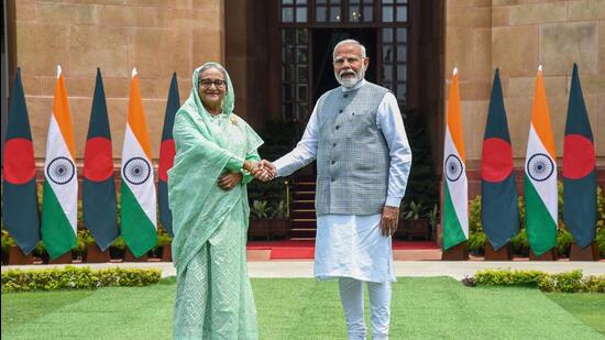 India's Prime Minister Narendra Modi shaking hands with his Bangladesh's counterpart Sheikh Hasina (L) upon their arrival at the Hyderabad house in New Delhi. (PTI)