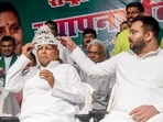 Rashtriya Janata Dal (RJD) chief Lalu Prasad Yadav wears a sliver crown during the party's 28th foundation day, at party office, in Patna on Friday. Leader of Opposition in Bihar Assembly Tejashwi Yadav is also seen. (Pappi Sharma/ANI ) Rashtriya Janata Dal (RJD) chief Lalu Prasad Yadav wears a sliver crown during the party's 28th foundation day, at party office, in Patna on Friday. Leader of Opposition in Bihar Assembly Tejashwi Yadav is also seen. (Pappi Sharma/ANI )