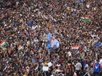 Fans wait for the arrival of Indian cricket team members for a victory parade to celebrate winning the ICC men's T20 World Cup, along the Marine Drive in Mumbai, India