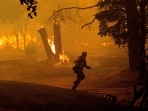 A firefighter runs while battling the Thompson Fire burning in Oroville, Calif., Tuesday, July 2, 2024. An extended heat wave blanketing Northern California has resulted in red flag fire warnings and power shutoffs. (AP Photo/Noah Berger) A firefighter runs while battling the Thompson Fire burning in Oroville, Calif., Tuesday, July 2, 2024. An extended heat wave blanketing Northern California has resulted in red flag fire warnings and power shutoffs. (AP Photo/Noah Berger)