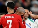 Cristiano Ronaldo comforts Portugal's Pepe.