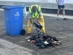 A BMC worker cleans up the detritus of Thursday's celebrations on Marine Drive. HT Photo
