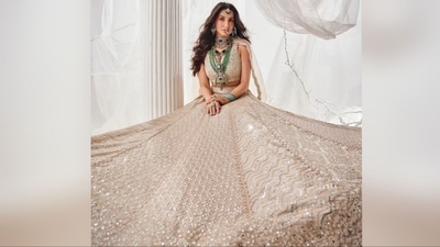 Nora's second look is equally stunning, featuring a beige lehenga with a sleeveless deep V-neck blouse paired with a flared skirt adorned with intricate silver sequin embroidery all over and a sheer duppata. (Instagram/@norafatehi) Nora's second look is equally stunning, featuring a beige lehenga with a sleeveless deep V-neck blouse paired with a flared skirt adorned with intricate silver sequin embroidery all over and a sheer duppata. (Instagram/@norafatehi)