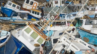 A fisherman looks at fishing vessels damaged by Hurricane Beryl at the Bridgetown Fisheries in Barbados, Monday, July 1, 2024. (AP Photo/Ricardo Mazalan) (AP) A fisherman looks at fishing vessels damaged by Hurricane Beryl at the Bridgetown Fisheries in Barbados, Monday, July 1, 2024. (AP Photo/Ricardo Mazalan) (AP)