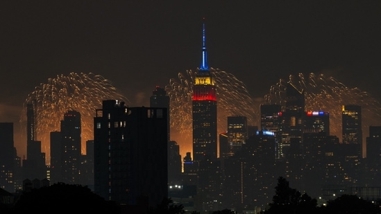 NEW YORK, NEW YORK - JULY 4: The Macy's 4th Of July fireworks show lights up the night sky as a backdrop to the Empire State Building on July 4, 2024 in New York City. The annual spectacle, lighting up the city since 1976, this time was launched from barges in the Hudson River, the first time in more than a decade not done from the East River.&nbsp;(Getty Images via AFP/Adam Gray)