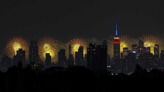 NEW YORK, NEW YORK - JULY 4: The Macy's 4th Of July fireworks show lights up the night sky as a backdrop to the Empire State Building on July 4, 2024 in New York City. The annual spectacle, lighting up the city since 1976, this time was launched from barges in the Hudson River, the first time in more than a decade not done from the East River.&nbsp;(Getty Images via AFP/Adam Gray)