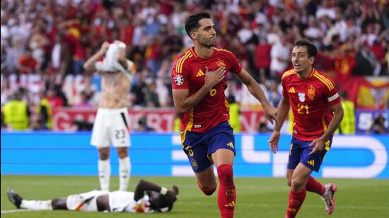 Spain's Mikel Merino celebrates after scoring his side’s second goal during their quarter-final against Germany on Friday (AP)