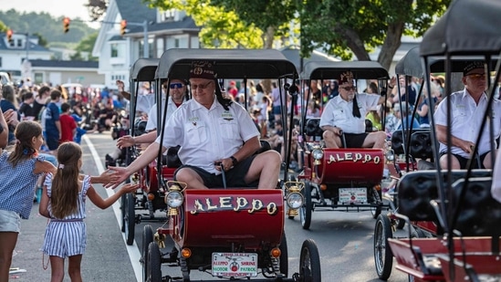 Members of the Aleppo Shriners ride vintage-looking cars during the Fishtown Horribles Parade ahead of Independence Day in Gloucester, Massachusetts, on July 3, 2024. The parade is part of the city's July 4th celebrations.&nbsp;(AFP/Joseph Prezioso)