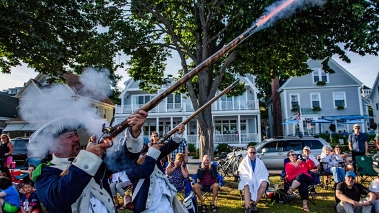Colonial reenactors fire their guns during the Fishtown Horribles Parade, ahead of Independence Day, in Gloucester, Massachusetts, on July 3, 2024. The parade is part of the city's July 4th celebrations.&nbsp;(AFP/Joseph Prezioso)