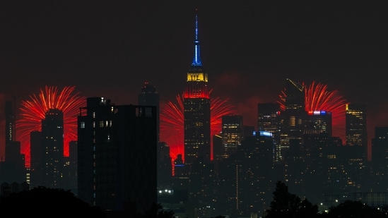 NEW YORK, NEW YORK - JULY 4: The Macy's 4th Of July fireworks show lights up the night sky as a backdrop to the Empire State Building on July 4, 2024 in New York City. The annual spectacle, lighting up the city since 1976, this time was launched from barges in the Hudson River, the first time in more than a decade not done from the East River.&nbsp;(Getty Images via AFP/ Adam Gray)