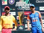Zimbabwe cricket captain Sikandar Razar, left, and India captain Shubman Gill pose with the trophy