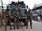 FILE PHOTO: Security personnel stand guard in front of their armoured vehicle outside a polling station during a rerun voting at 11 polling stations, in Imphal, Manipur, India, April 22, 2024. REUTERS/Stringer/File Photo(REUTERS)