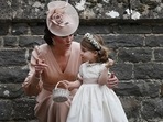 Britain's Catherine, Duchess of Cambridge (L) speaks to her daughter Britain's princess Charlotte, a bridesmaid, following the wedding of her sister Pippa Middleton to James Matthews at St Mark's Church in Englefield, west of London, on May 20, 2017. (KIRSTY WIGGLESWORTH / AFP)