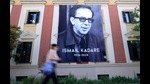 A woman walks by a banner with a portrait of renowned Albanian writer Ismail Kadare on the second day of national mourning following his death on July 1 2024, in Tirana, on July 3, 2024. (Photo by ADNAN BECI / AFP) (AFP) A woman walks by a banner with a portrait of renowned Albanian writer Ismail Kadare on the second day of national mourning following his death on July 1 2024, in Tirana, on July 3, 2024. (Photo by ADNAN BECI / AFP) (AFP)