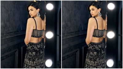 Her bralette-style blouse boasts spaghetti straps and a sweetheart neckline. She paired it with a matching flared skirt and a black sheer cape adorned with sequin borders, adding a touch of drama to her look. (Instagram/@aliaabhatt) Her bralette-style blouse boasts spaghetti straps and a sweetheart neckline. She paired it with a matching flared skirt and a black sheer cape adorned with sequin borders, adding a touch of drama to her look. (Instagram/@aliaabhatt)