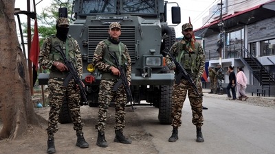 FILE PHOTO: Security personnel stand guard in front of their armoured vehicle outside a polling station during a rerun voting at 11 polling stations, in Imphal, Manipur, India, April 22, 2024. REUTERS/Stringer/File Photo (REUTERS)