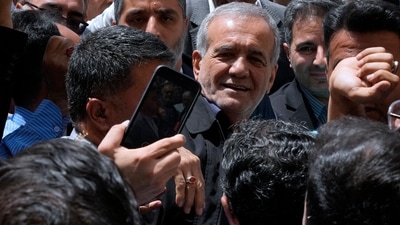 Reformist candidate for the Iran's presidential election Masoud Pezeshkian is greeted by his supporters as he arrives to vote at a polling station in Shahr-e-Qods near Tehran, Iran, Friday, July 5, 2024. (AP) Reformist candidate for the Iran's presidential election Masoud Pezeshkian is greeted by his supporters as he arrives to vote at a polling station in Shahr-e-Qods near Tehran, Iran, Friday, July 5, 2024. (AP)