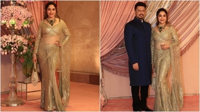 Madhuri Dixit wore a gold sequinned saree and a plunging neck blouse to Anant Ambani and Radhika Merchant's sangeet. Meanwhile, her husband, Shriram Madhav Nene, wore a navy blue bandhgala kurta, black pants, and dress shoes. (HT Photo/Varinder Chawla) Madhuri Dixit wore a gold sequinned saree and a plunging neck blouse to Anant Ambani and Radhika Merchant's sangeet. Meanwhile, her husband, Shriram Madhav Nene, wore a navy blue bandhgala kurta, black pants, and dress shoes. (HT Photo/Varinder Chawla)