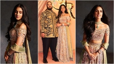 The star of the night, Radhika Merchant, wore a custom lehenga set designed by Abu Jani Sandeep Khosla. The off-shoulder blouse, A-line lehenga skirt, and silk dupatta are adorned with Swarovski crystals. A choker necklace, a bracelet, and dainty earrings rounded off Radhika's sangeet look. (Instagram) The star of the night, Radhika Merchant, wore a custom lehenga set designed by Abu Jani Sandeep Khosla. The off-shoulder blouse, A-line lehenga skirt, and silk dupatta are adorned with Swarovski crystals. A choker necklace, a bracelet, and dainty earrings rounded off Radhika's sangeet look. (Instagram)