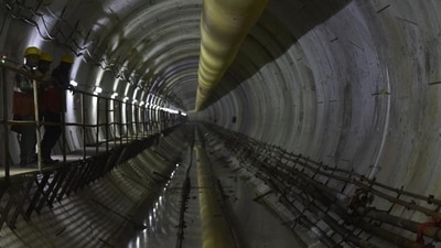 Workers at the underground station of Metro Line 3, below Mithi River at Bandra Kurla Complex Station. (Anshuman Poyrekar / HT Photo)