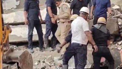 Rescue operations are underway to evacuate trapped residents after a multi storeyed building collapsed in Surat. (X/PTI) Rescue operations are underway to evacuate trapped residents after a multi storeyed building collapsed in Surat. (X/PTI)