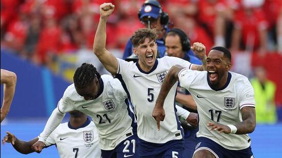 (From L) England's Eberechi Eze, John Stones and Ivan Toney celebrate at the end of the penalty shootout. (AFP)