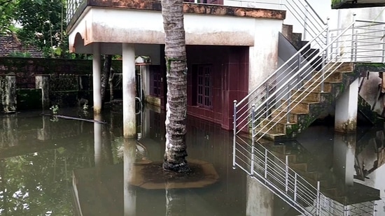 A view of a partially submerged house following heavy rainfall, at the residential areas of Aydar in Mangaluru on Friday. (ANI Photo)(ANI)