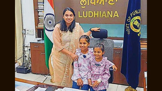 DC Sakshi Sawhney with Gurleen, 10, (L) and Komaldeep, 7, in the deputy commissioner’s office in Ludhiana on Saturday (HT Photo)