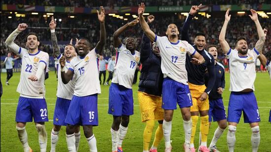 France players celebrate after winning the Euro 2024 quarter-final against Portugal in Hamburg on Friday. (AP)