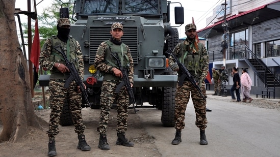 FILE PHOTO: Security personnel stand guard in front of their armoured vehicle outside a polling station during a rerun voting at 11 polling stations, in Imphal, Manipur, India, April 22, 2024. REUTERS/Stringer/File Photo(REUTERS)