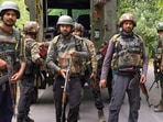 Security personnel stand guard during an encounter with terrorists, in Kulgam, Jammu and Kashmir. Security personnel stand guard during an encounter with terrorists, in Kulgam, Jammu and Kashmir.
