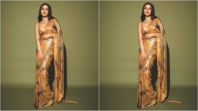 Her stunning saree boasts a captivating blend of gunmetal and brown hues, adorned with enchanting floral prints. She draped the nine yards in a traditional style, allowing the pallu to cascade gracefully from her shoulder, sweeping the floor with elegance. (Instagram/@Shehnaaz Gill) Her stunning saree boasts a captivating blend of gunmetal and brown hues, adorned with enchanting floral prints. She draped the nine yards in a traditional style, allowing the pallu to cascade gracefully from her shoulder, sweeping the floor with elegance. (Instagram/@Shehnaaz Gill)