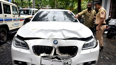 Mumbai, Jul 07 (ANI): Police personnel inspect a BMW car that ran over two people riding a bike, at Worli Police Station in Mumbai on Sunday. One woman died and one person injured in the accident. (ANI Photo) (Vijay Gohil) Mumbai, Jul 07 (ANI): Police personnel inspect a BMW car that ran over two people riding a bike, at Worli Police Station in Mumbai on Sunday. One woman died and one person injured in the accident. (ANI Photo) (Vijay Gohil)