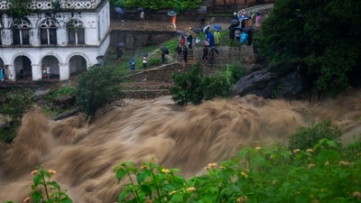 People watch the flooded Bagmati river in Kathmandu, Nepal, Saturday, July 6, 2024. AP/PTI (AP) People watch the flooded Bagmati river in Kathmandu, Nepal, Saturday, July 6, 2024. AP/PTI (AP)