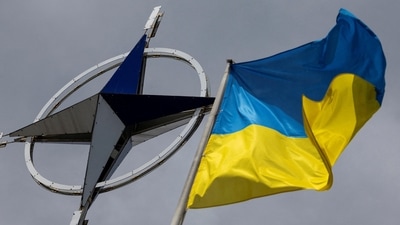 A Ukrainian national flag is pictured in front of the NATO emblem (REUTERS file photo)
