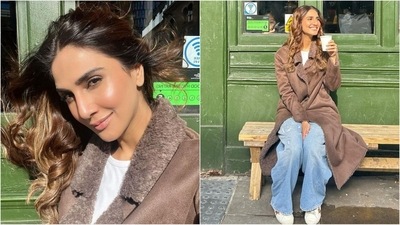 Vaani Kapoor is enjoying her holiday, and her stylish vacation looks are a treat for all fashion lovers. Her latest ensemble features a trendy brown trench coat with fur collars. Paired with a white tank top and blue baggy jeans, she perfectly complements her chic look. (Instagram/@vaanikapoor) Vaani Kapoor is enjoying her holiday, and her stylish vacation looks are a treat for all fashion lovers. Her latest ensemble features a trendy brown trench coat with fur collars. Paired with a white tank top and blue baggy jeans, she perfectly complements her chic look. (Instagram/@vaanikapoor)
